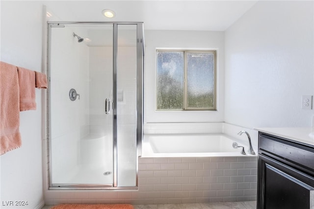 bathroom featuring vanity and separate shower and tub