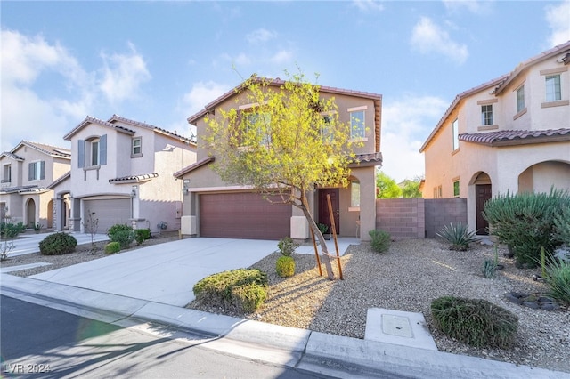 mediterranean / spanish-style home with a garage