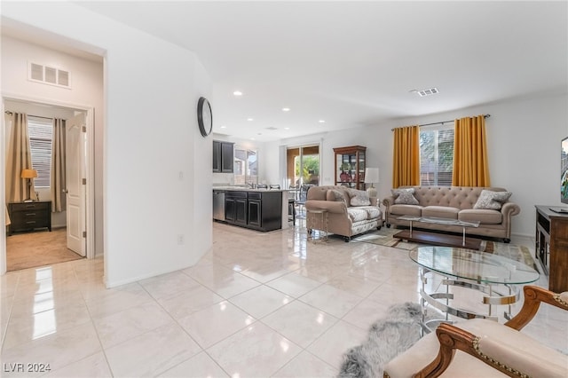 tiled living room with plenty of natural light and sink