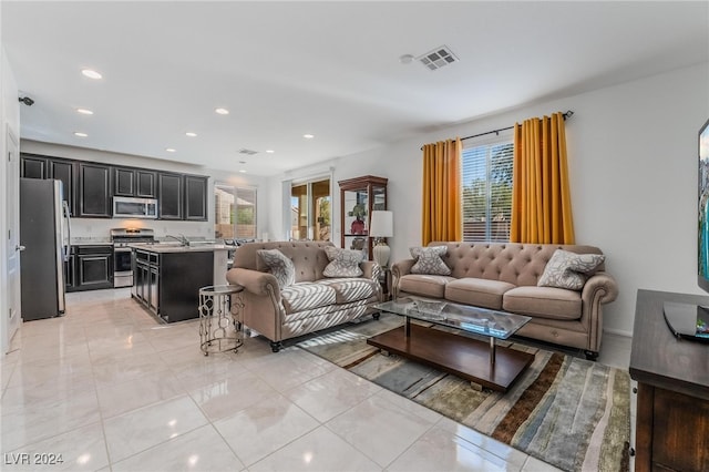 living room with light tile patterned floors and sink