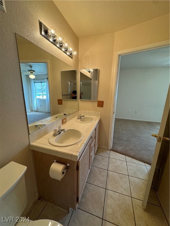 bathroom with vanity, a textured ceiling, tile patterned flooring, ceiling fan, and toilet