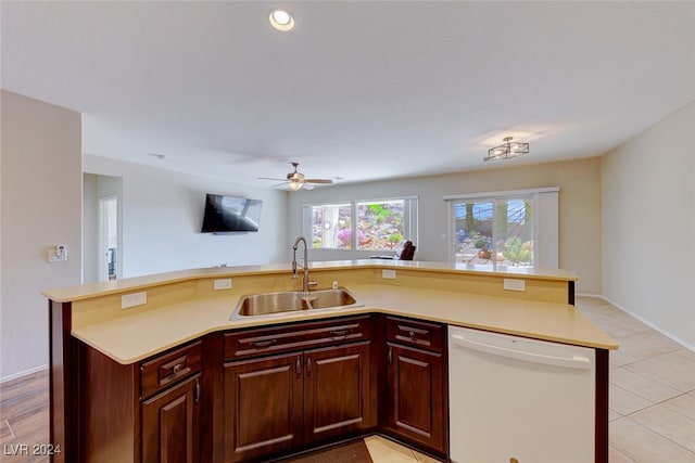 kitchen featuring light tile patterned flooring, sink, a center island with sink, white dishwasher, and ceiling fan