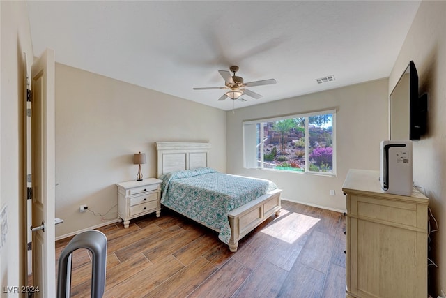 bedroom with ceiling fan and hardwood / wood-style flooring