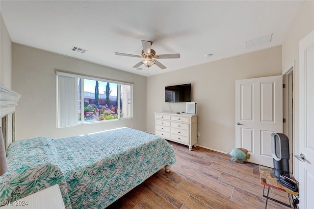 bedroom with ceiling fan and light hardwood / wood-style flooring