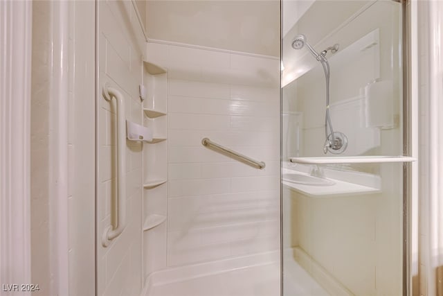 bathroom with a shower with shower door