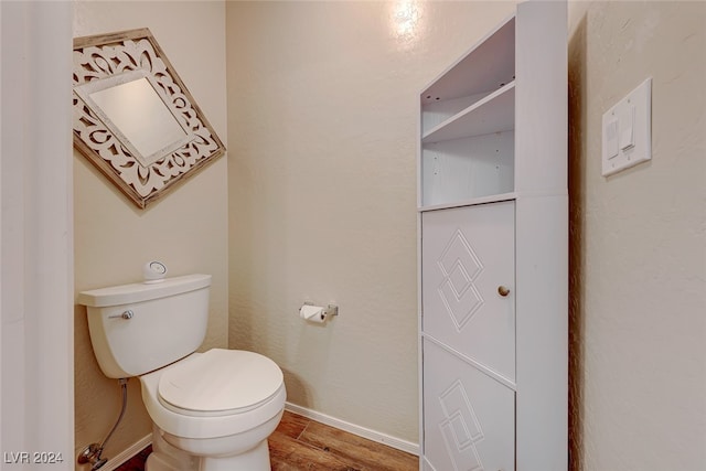 bathroom with wood-type flooring and toilet