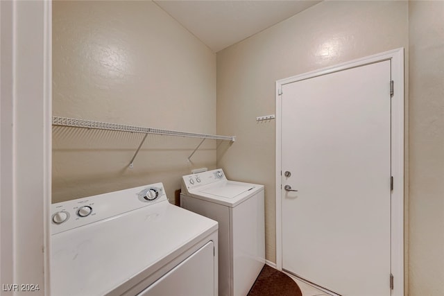 laundry room with washing machine and clothes dryer