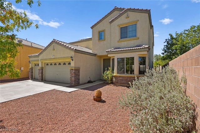 mediterranean / spanish-style house with a garage