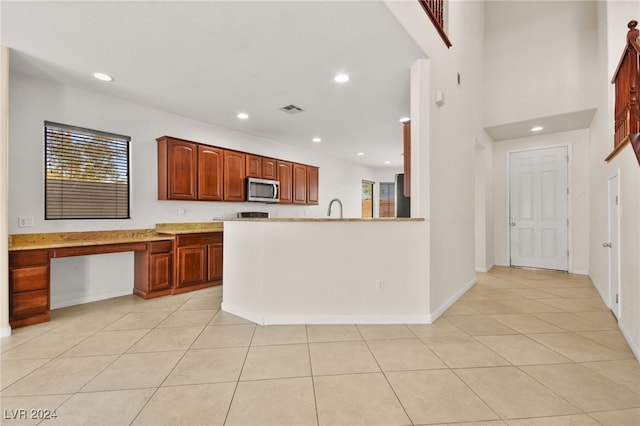 kitchen featuring light tile patterned floors and sink