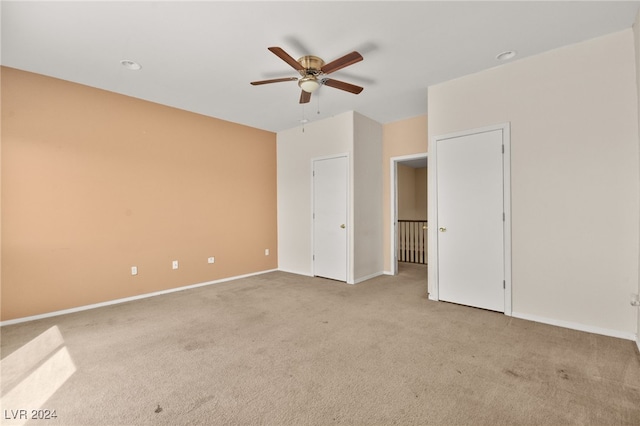 unfurnished bedroom featuring ceiling fan and light colored carpet