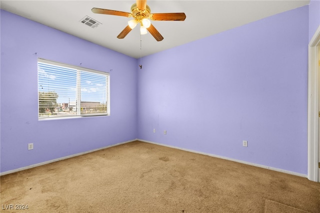 unfurnished room featuring ceiling fan and light carpet