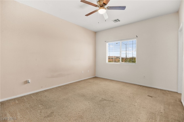 carpeted spare room featuring ceiling fan