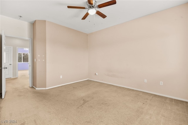 carpeted spare room with ceiling fan