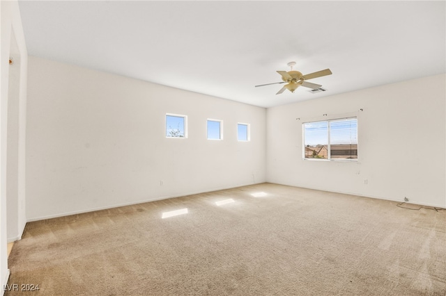 unfurnished room featuring light carpet and ceiling fan