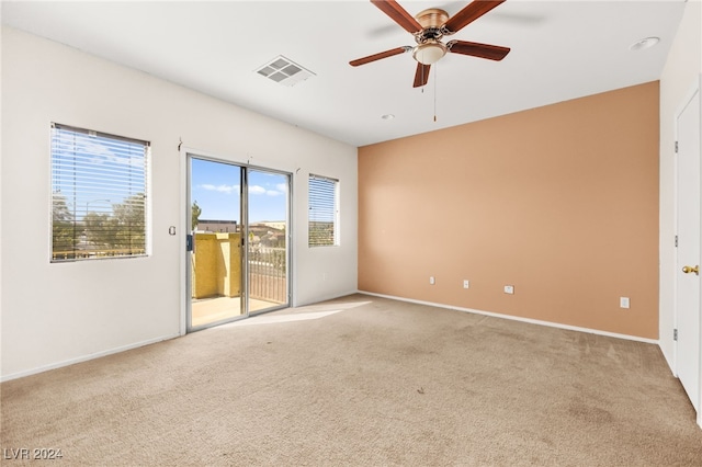 carpeted empty room featuring ceiling fan