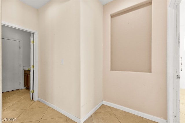 corridor featuring light tile patterned floors