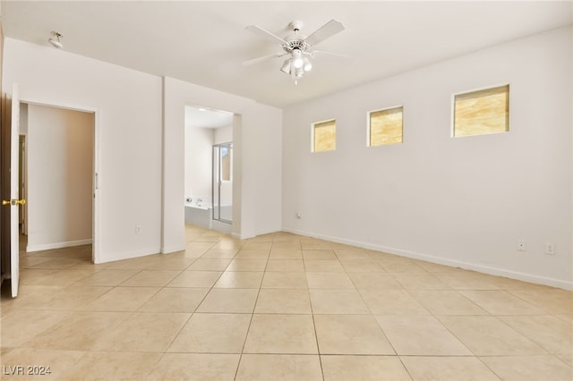 unfurnished room with light tile patterned floors and ceiling fan