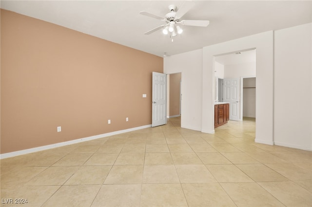 unfurnished room with ceiling fan and light tile patterned floors