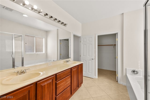 bathroom featuring tile patterned floors, vanity, and separate shower and tub