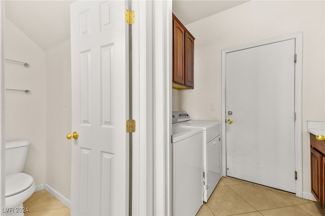 washroom featuring washer and clothes dryer and light tile patterned floors