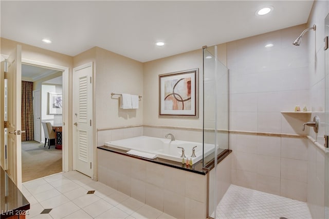 bathroom with tile patterned flooring and separate shower and tub