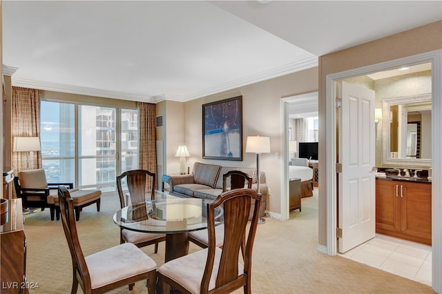 dining area with sink and crown molding