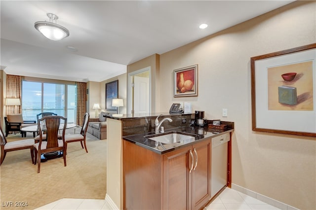 kitchen featuring sink, kitchen peninsula, light carpet, ornamental molding, and white dishwasher