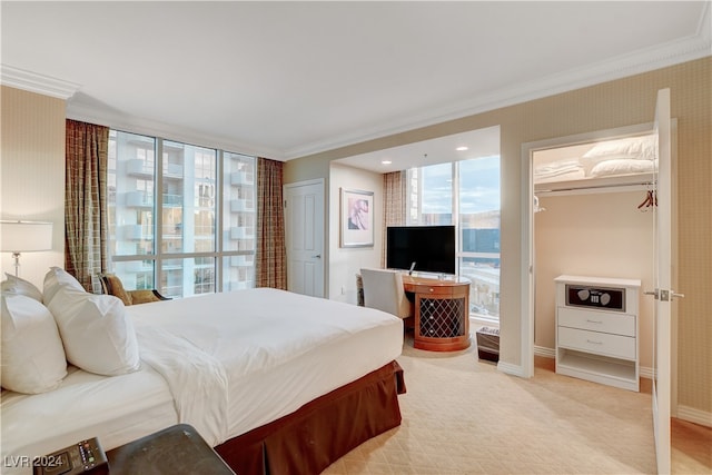 bedroom with crown molding, light carpet, and a closet