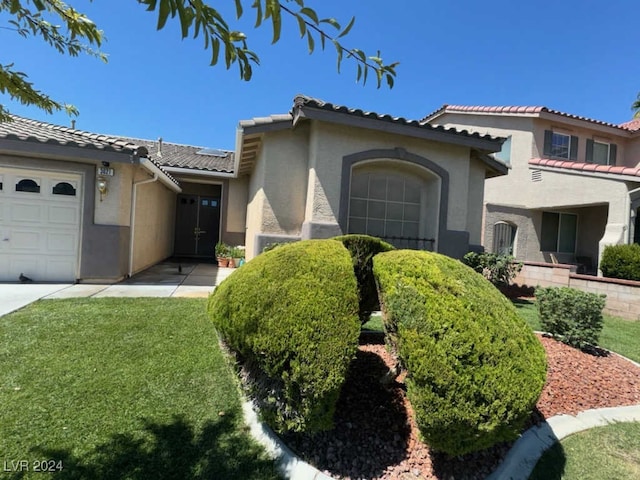 view of front of house with a front yard and a garage