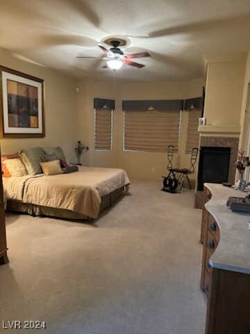 bedroom with ceiling fan and light colored carpet