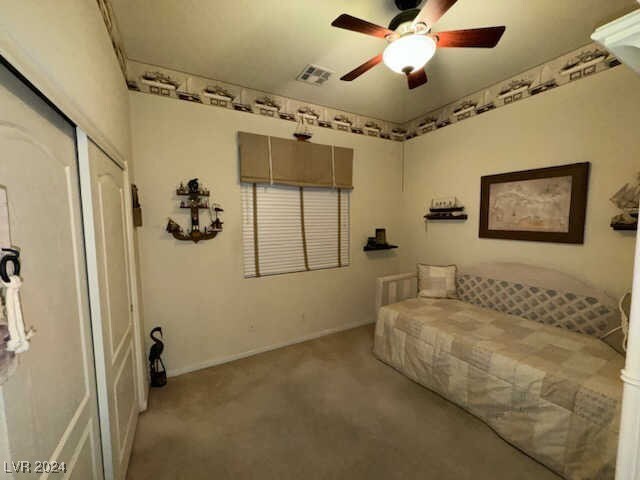 unfurnished bedroom featuring a closet, ceiling fan, and light colored carpet