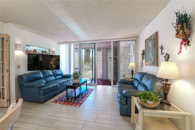 living room featuring expansive windows and a textured ceiling