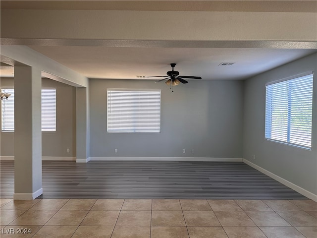 spare room with ceiling fan and light wood-type flooring