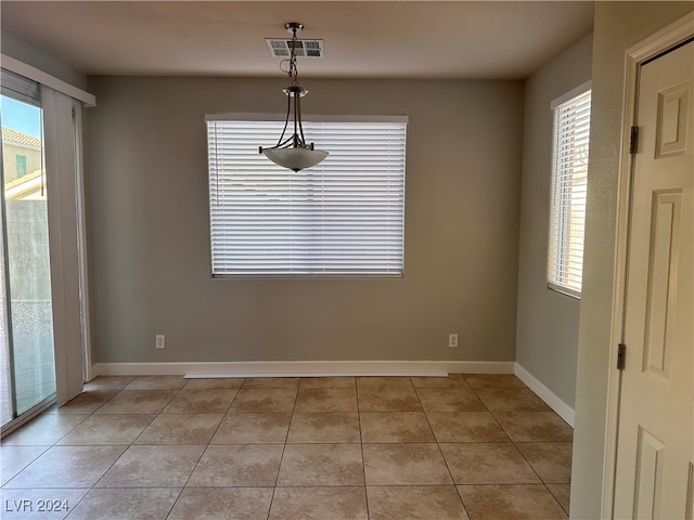 unfurnished dining area featuring light tile patterned floors