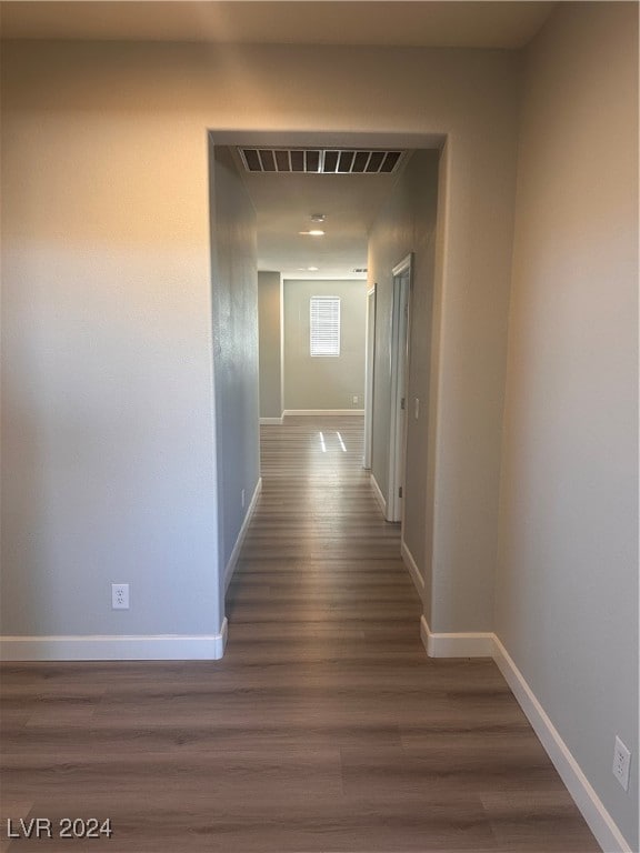 corridor with dark hardwood / wood-style floors