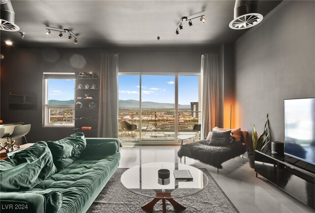 living room with concrete flooring and plenty of natural light