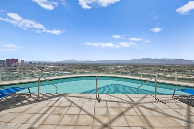 view of swimming pool featuring a mountain view