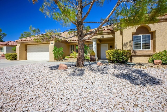 mediterranean / spanish-style house with a garage