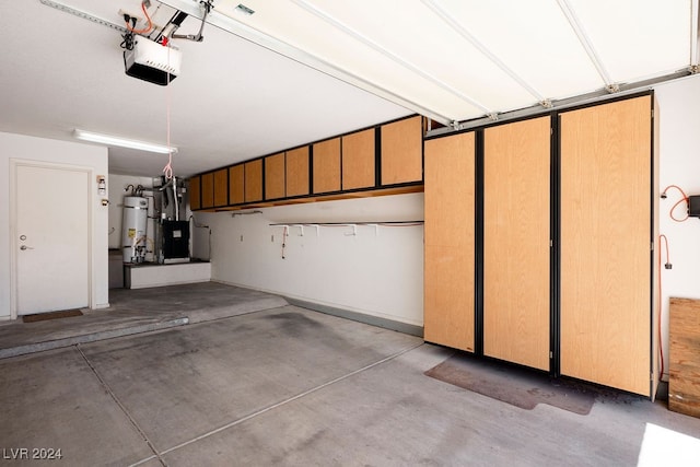 garage with strapped water heater and a garage door opener