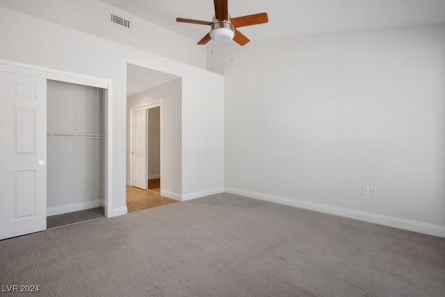 unfurnished bedroom with ceiling fan, a closet, and light carpet