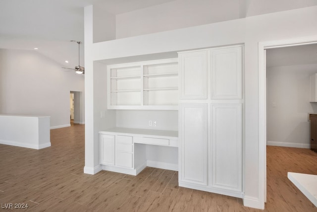 interior space with a high ceiling, light hardwood / wood-style flooring, and ceiling fan