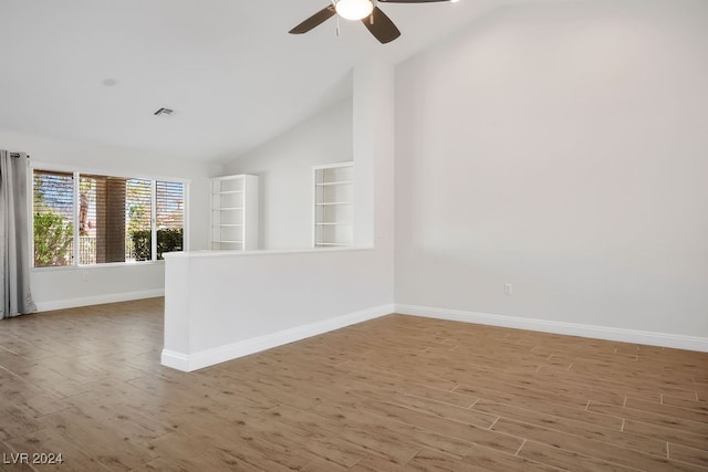 empty room with hardwood / wood-style flooring, ceiling fan, and lofted ceiling