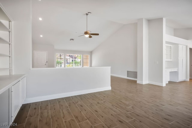 empty room featuring ceiling fan, dark hardwood / wood-style flooring, and vaulted ceiling