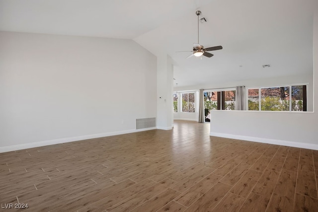 unfurnished living room featuring dark hardwood / wood-style flooring, vaulted ceiling, and ceiling fan