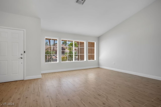 interior space with light hardwood / wood-style flooring and vaulted ceiling