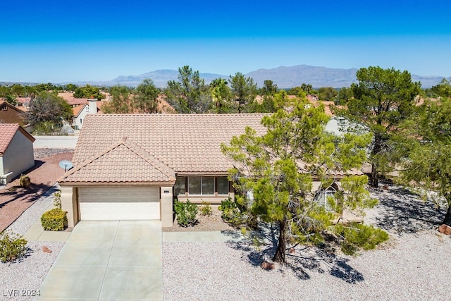 ranch-style house featuring a mountain view and a garage