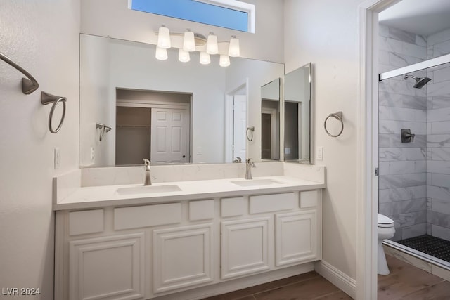 bathroom featuring vanity, hardwood / wood-style flooring, toilet, and walk in shower