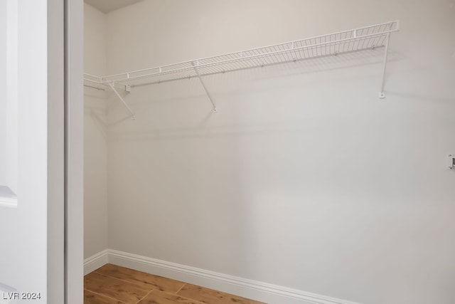 spacious closet with hardwood / wood-style floors