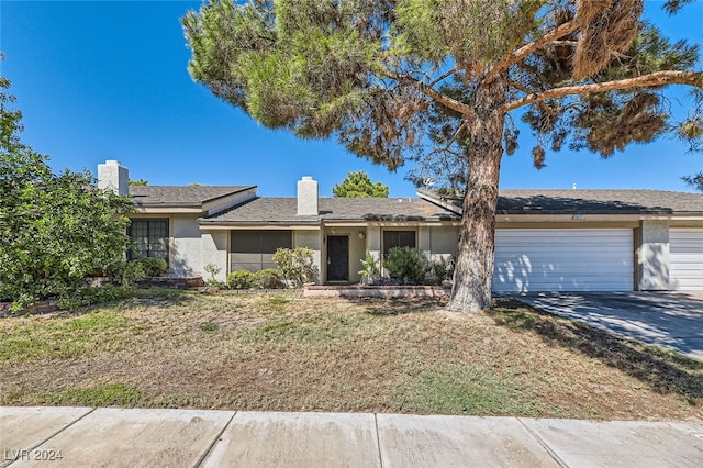 ranch-style home featuring a garage and a front yard