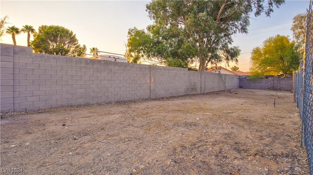 view of yard at dusk